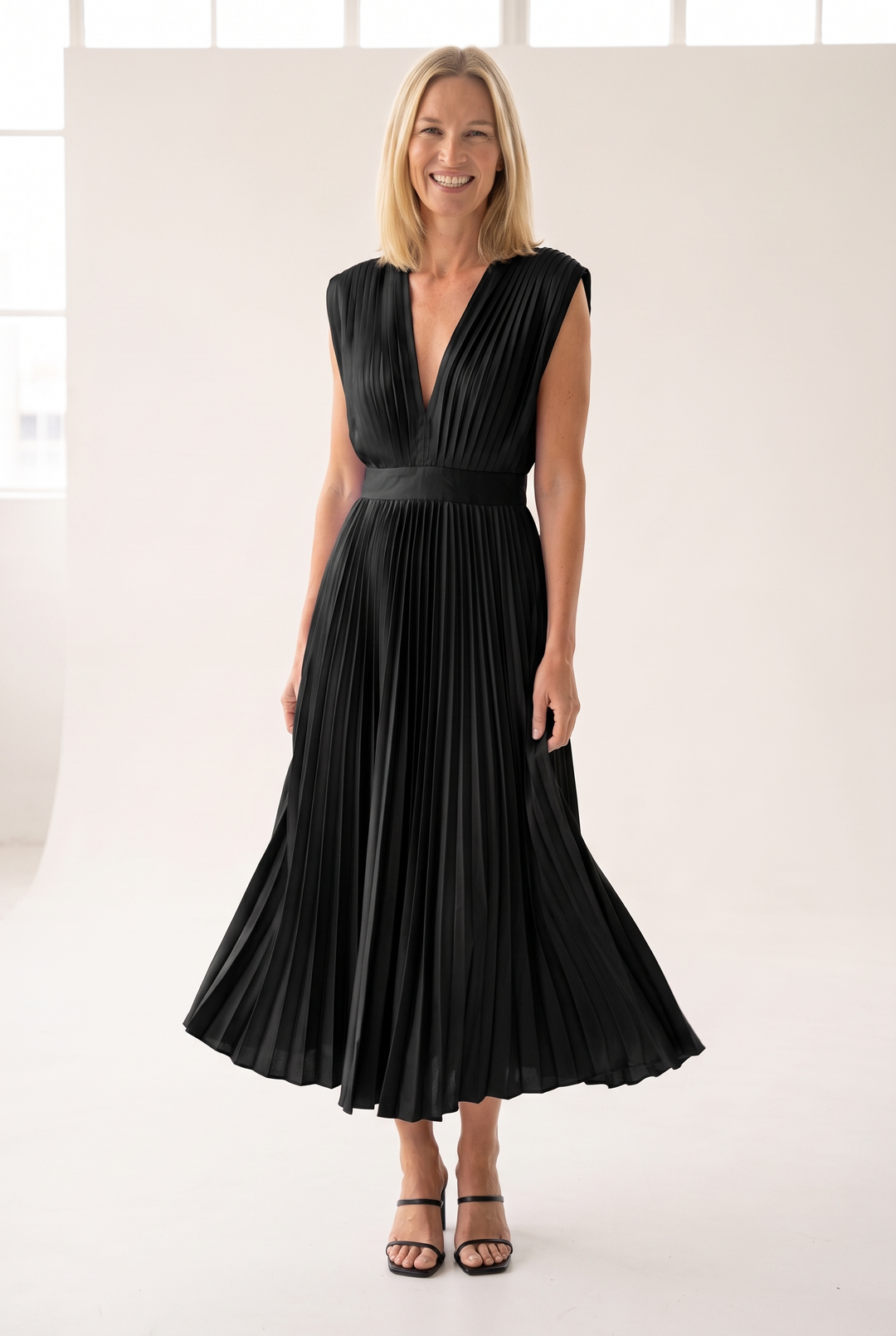 Woman wearing pleated satin midi dress