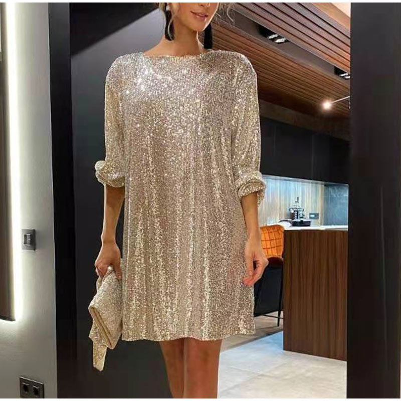 Woman wearing sparkling sequin mini dress with waist tie detail