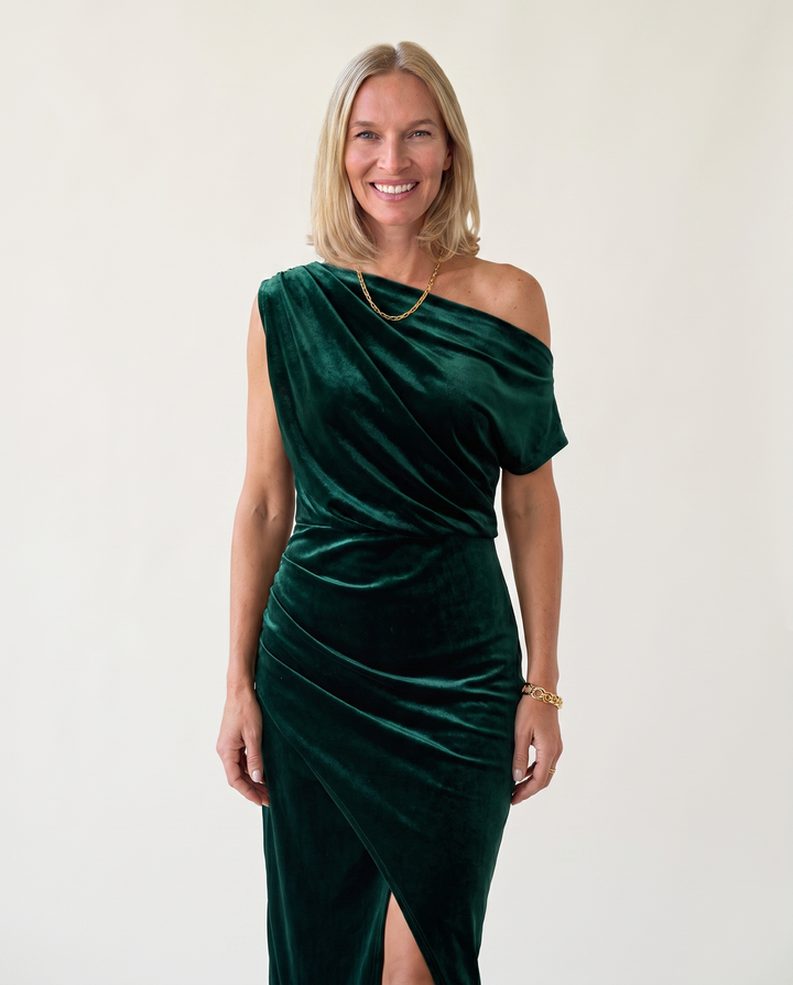 Woman wearing one-shoulder midi dress with luxe velvet finish