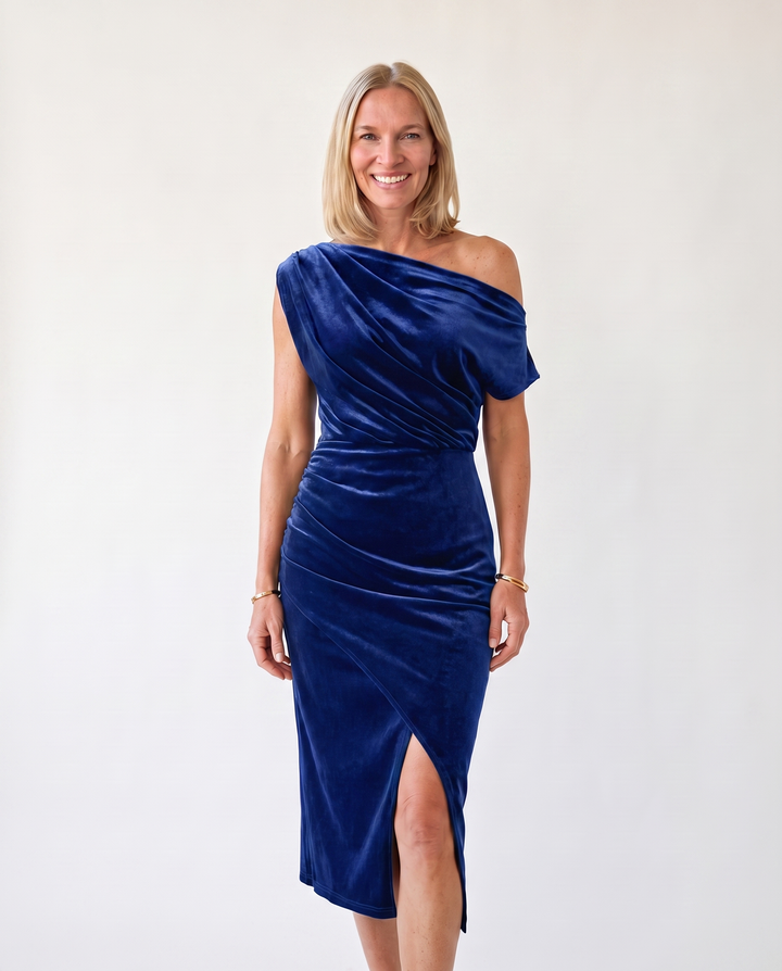 Woman wearing one-shoulder midi dress with luxe velvet finish