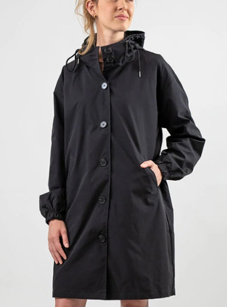 Woman wearing long hooded rain jacket