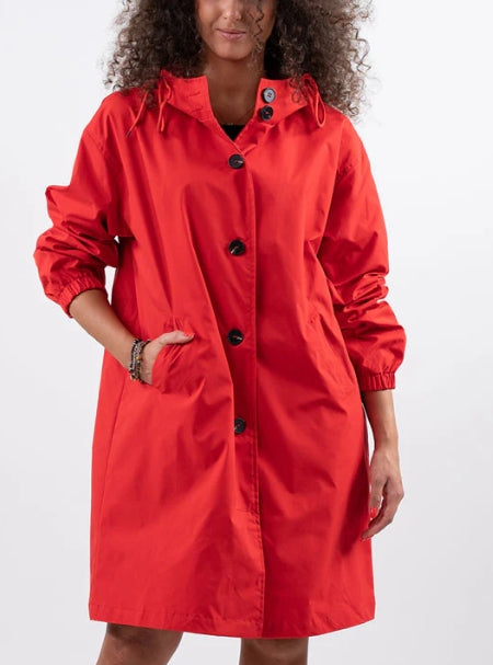 Woman wearing long hooded rain jacket