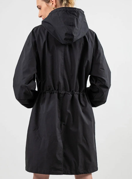 Woman wearing long hooded rain jacket