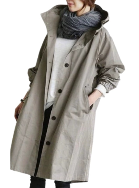 Woman wearing long hooded rain jacket