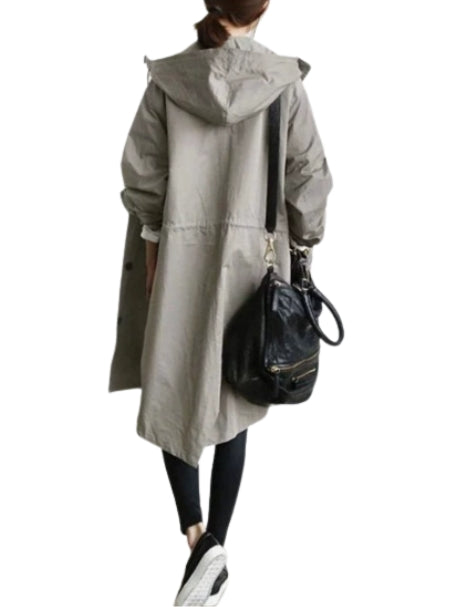 Woman wearing long hooded rain jacket