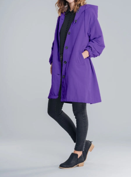 Woman wearing long hooded rain jacket