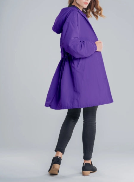 Woman wearing long hooded rain jacket