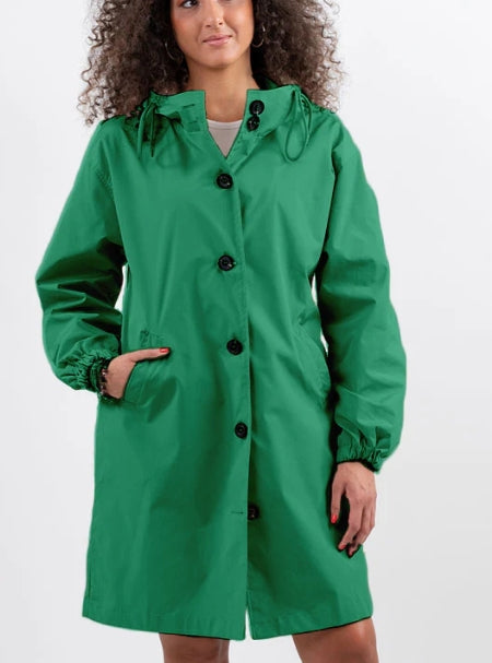 Woman wearing long hooded rain jacket