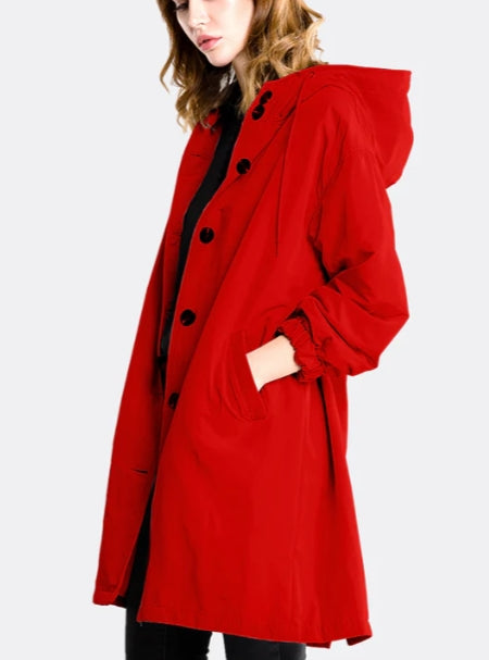 Woman wearing long hooded rain jacket