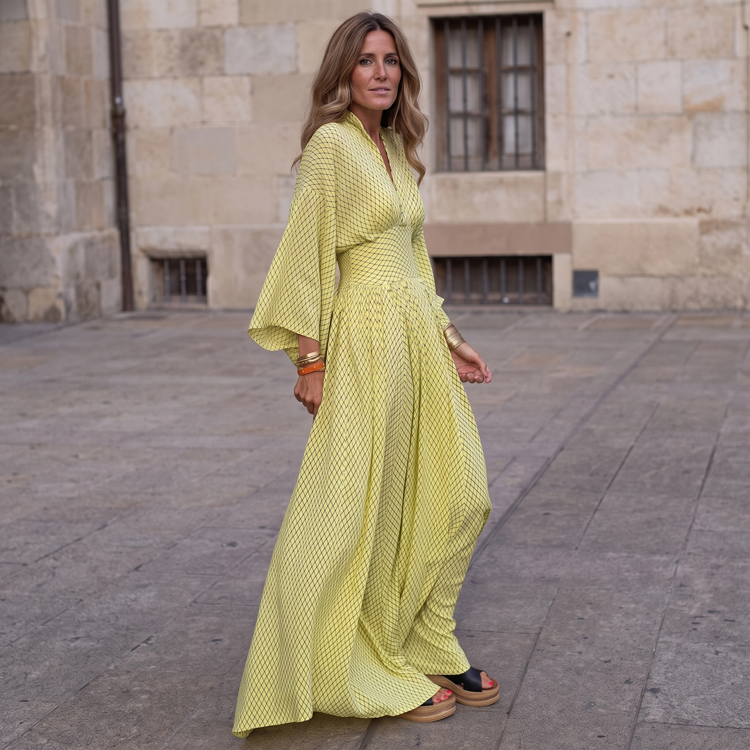 Woman wearing elegant long sleeve maxi dress with flowing silhouette