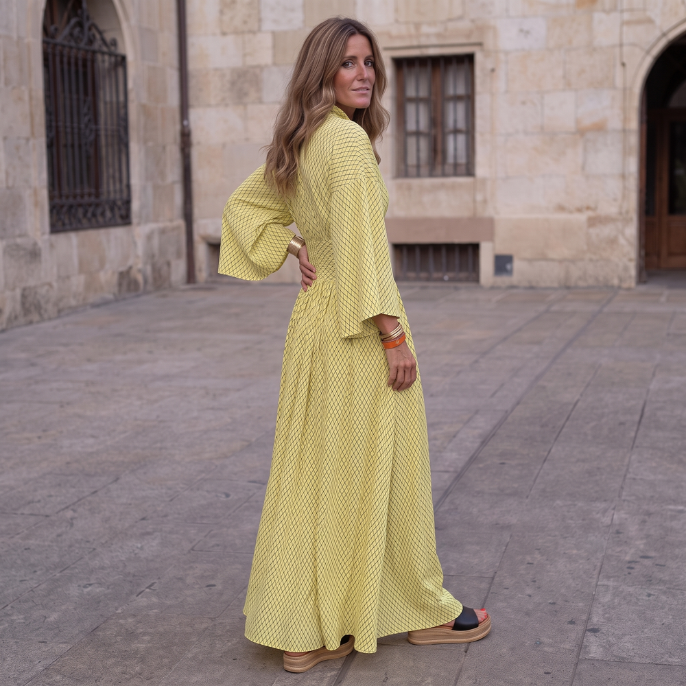 Woman wearing elegant long sleeve maxi dress with flowing silhouette