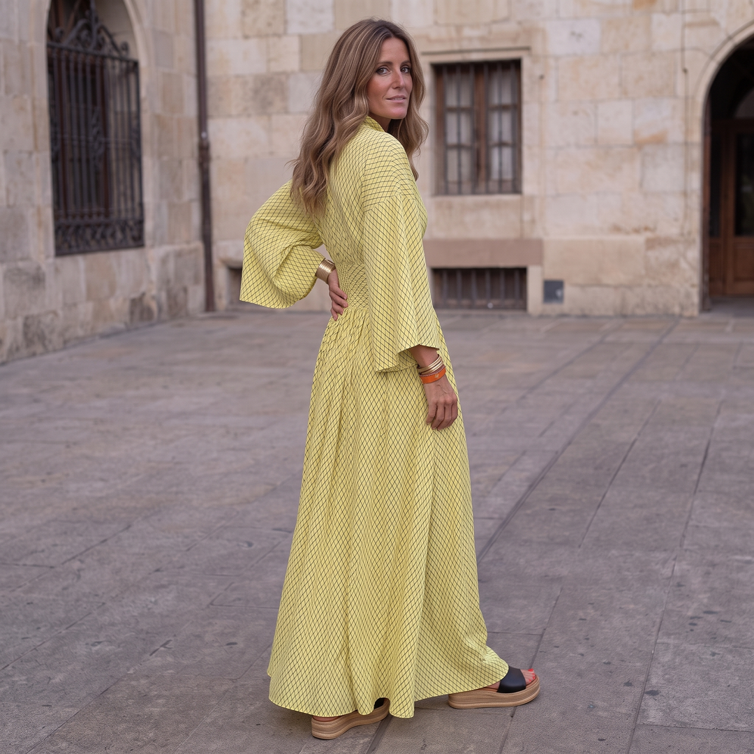 Woman wearing elegant long sleeve maxi dress with flowing silhouette