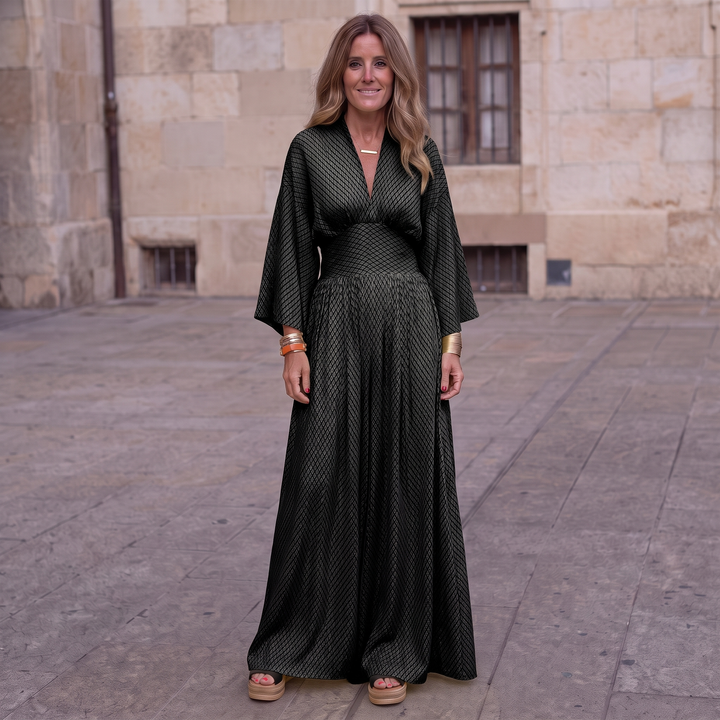 Woman wearing elegant long sleeve maxi dress with flowing silhouette