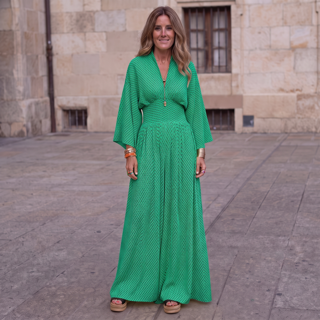 Woman wearing elegant long sleeve maxi dress with flowing silhouette