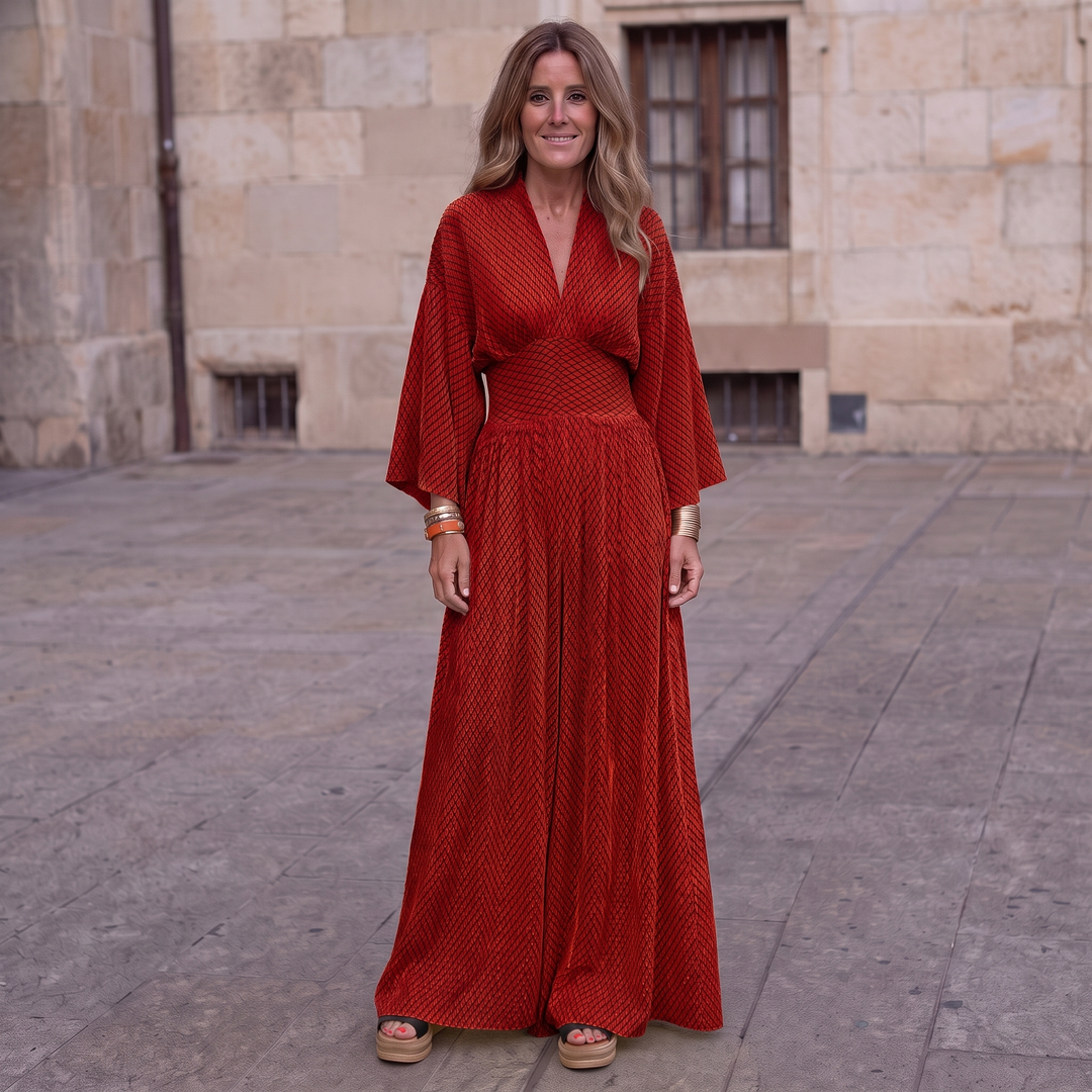 Woman wearing elegant long sleeve maxi dress with flowing silhouette