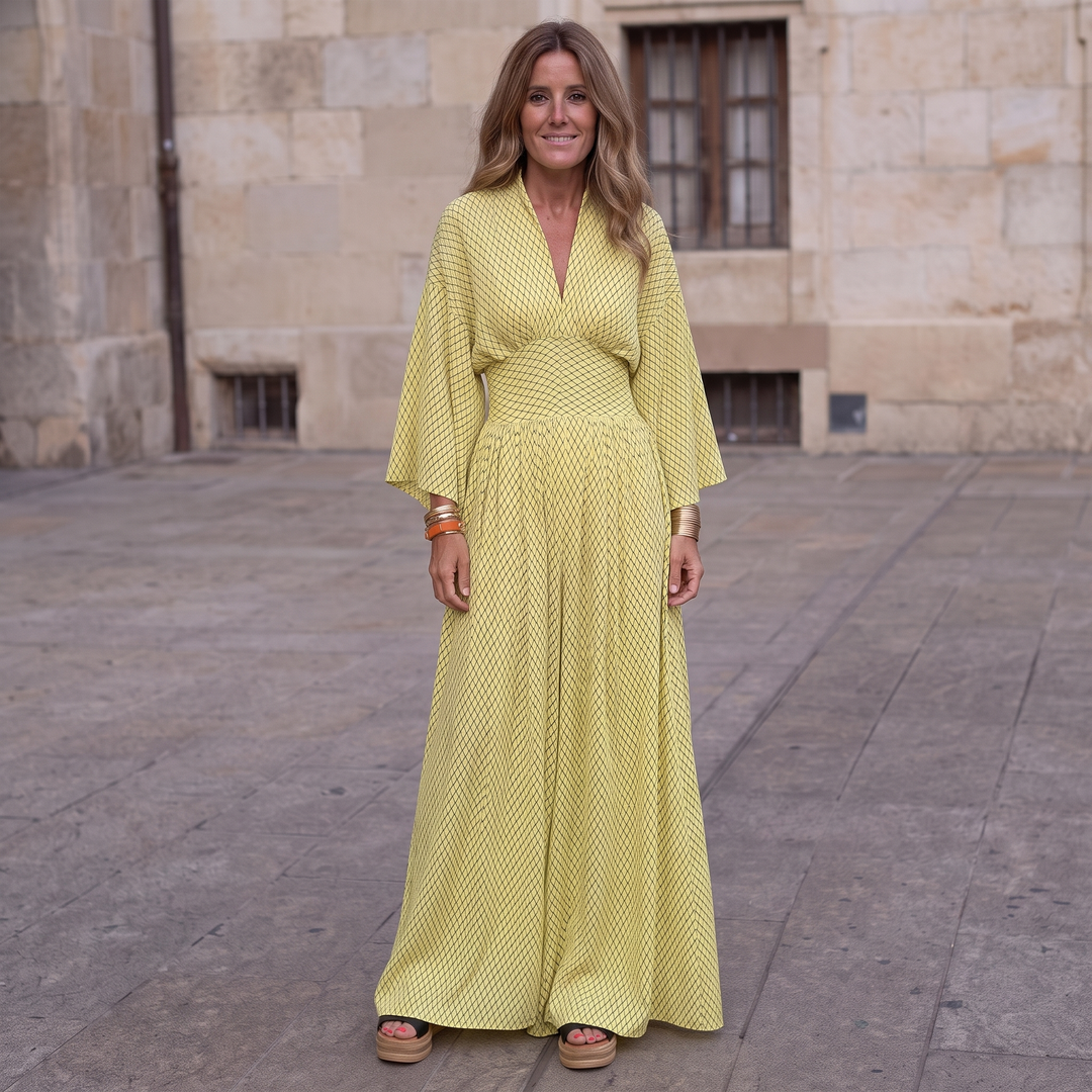 Woman wearing elegant long sleeve maxi dress with flowing silhouette