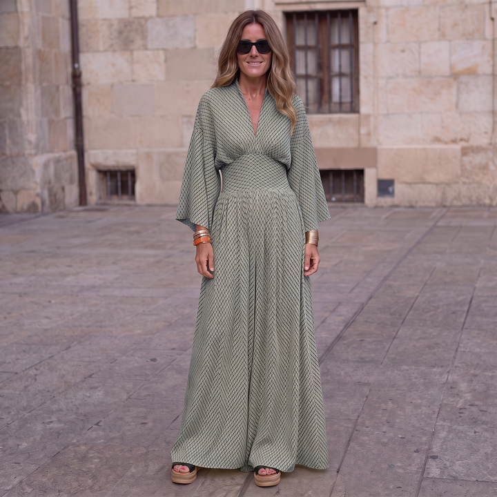 Woman wearing elegant long sleeve maxi dress with flowing silhouette