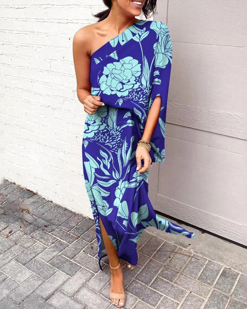 Woman wearing one-shoulder floral maxi dress with flowing silhouette