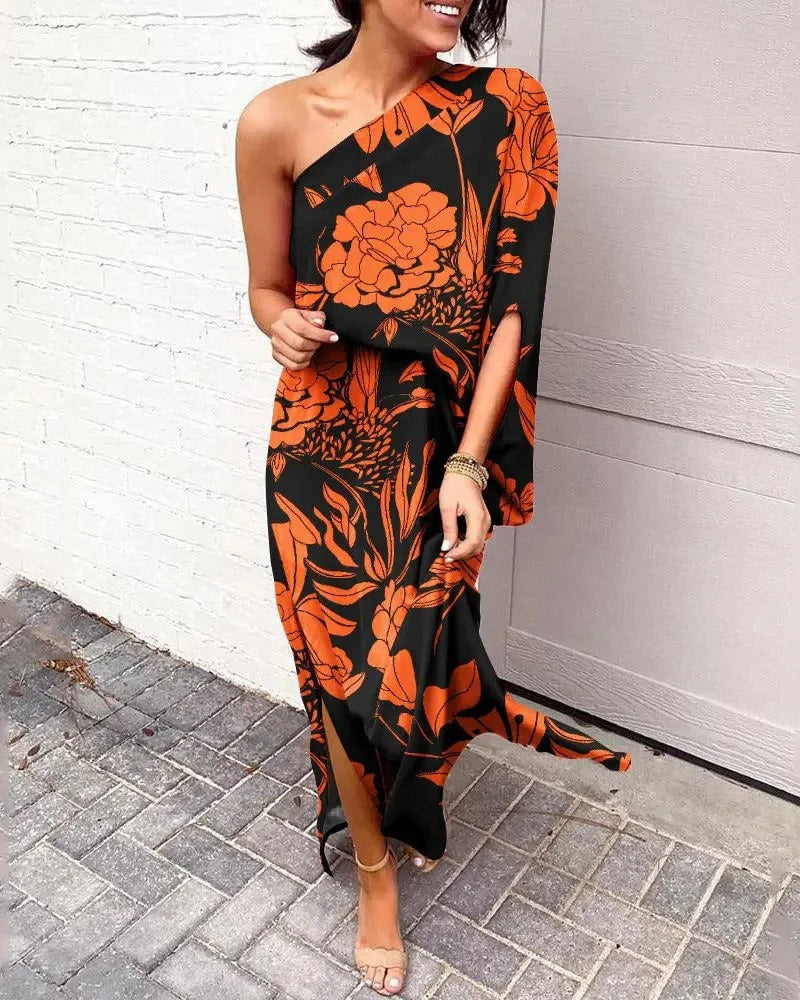 Woman wearing one-shoulder floral maxi dress with flowing silhouette