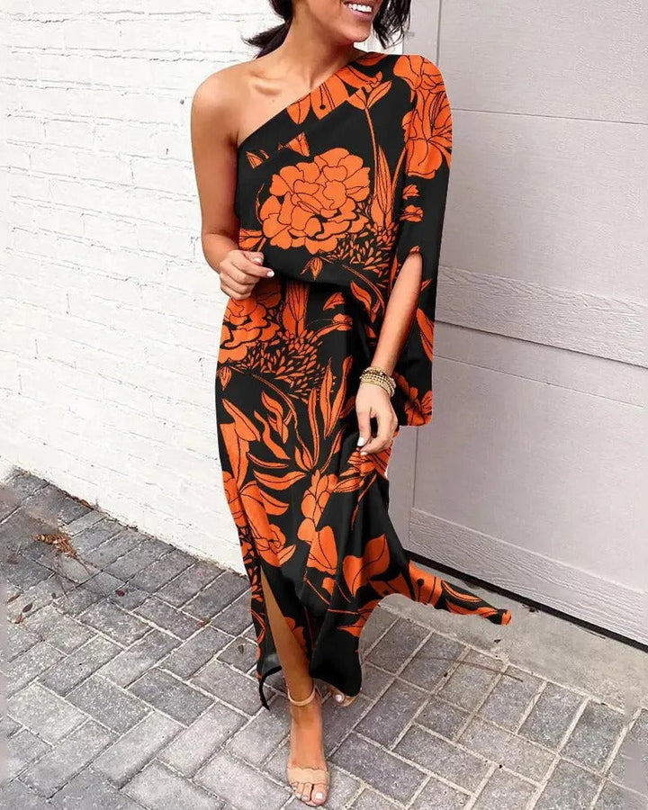 Woman wearing one-shoulder floral maxi dress with flowing silhouette
