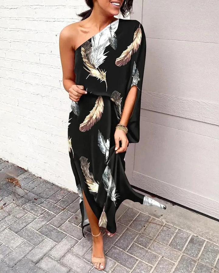 Woman wearing one-shoulder floral maxi dress with flowing silhouette