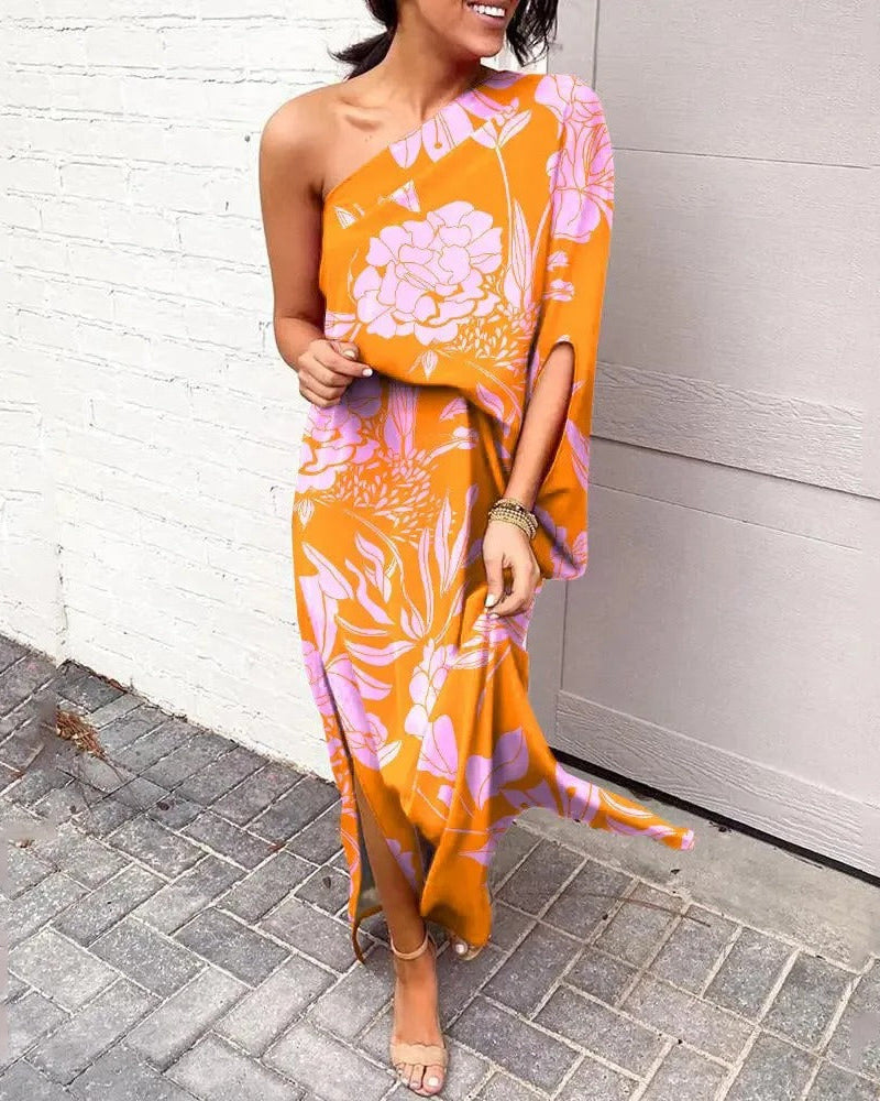 Woman wearing one-shoulder floral maxi dress with flowing silhouette
