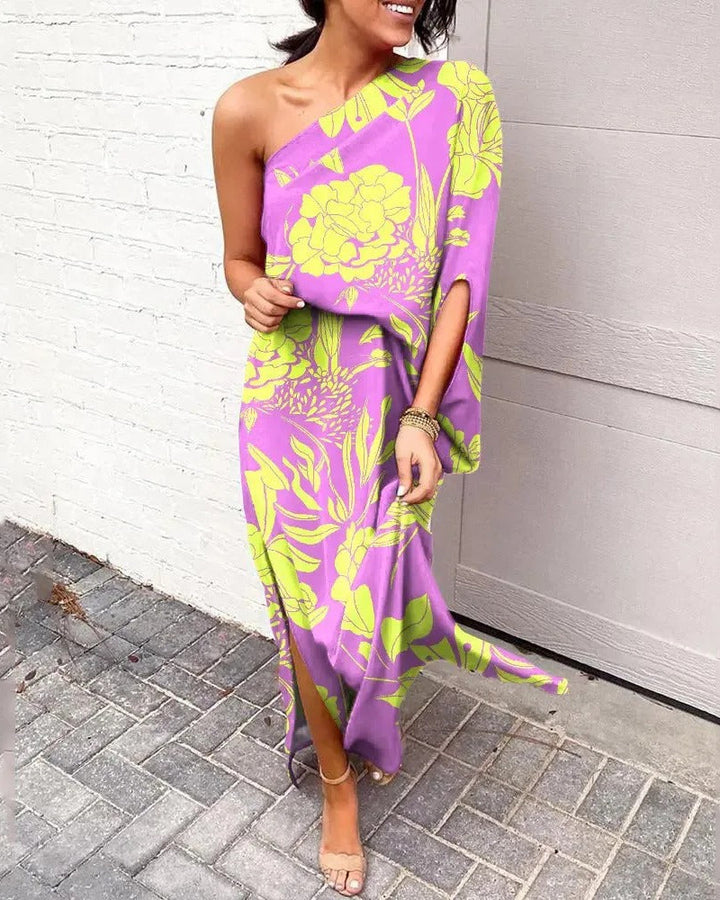 Woman wearing one-shoulder floral maxi dress with flowing silhouette