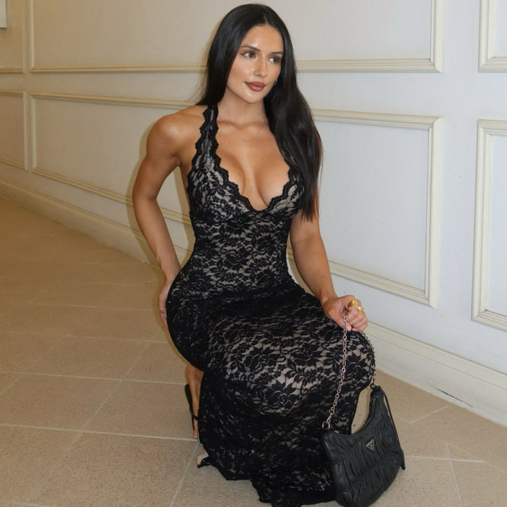 Woman wearing black lace halter backless maxi dress
