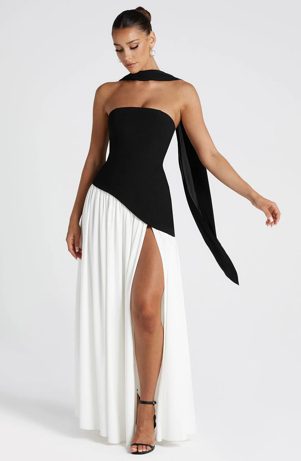 Woman wearing strapless split evening maxi dress