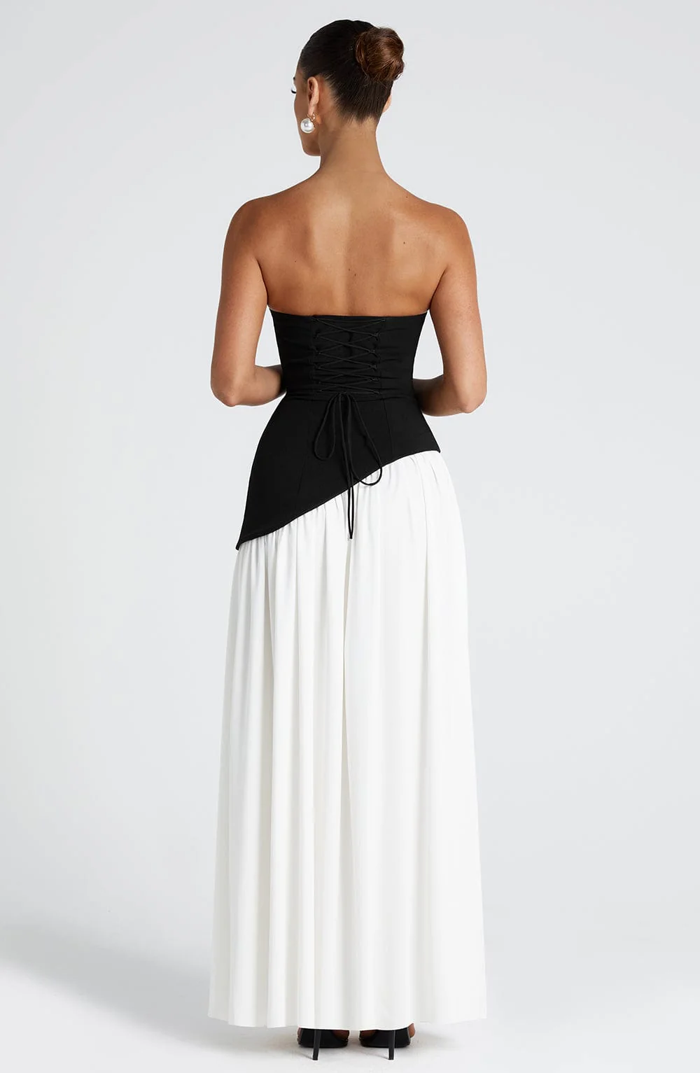 Woman wearing strapless split evening maxi dress