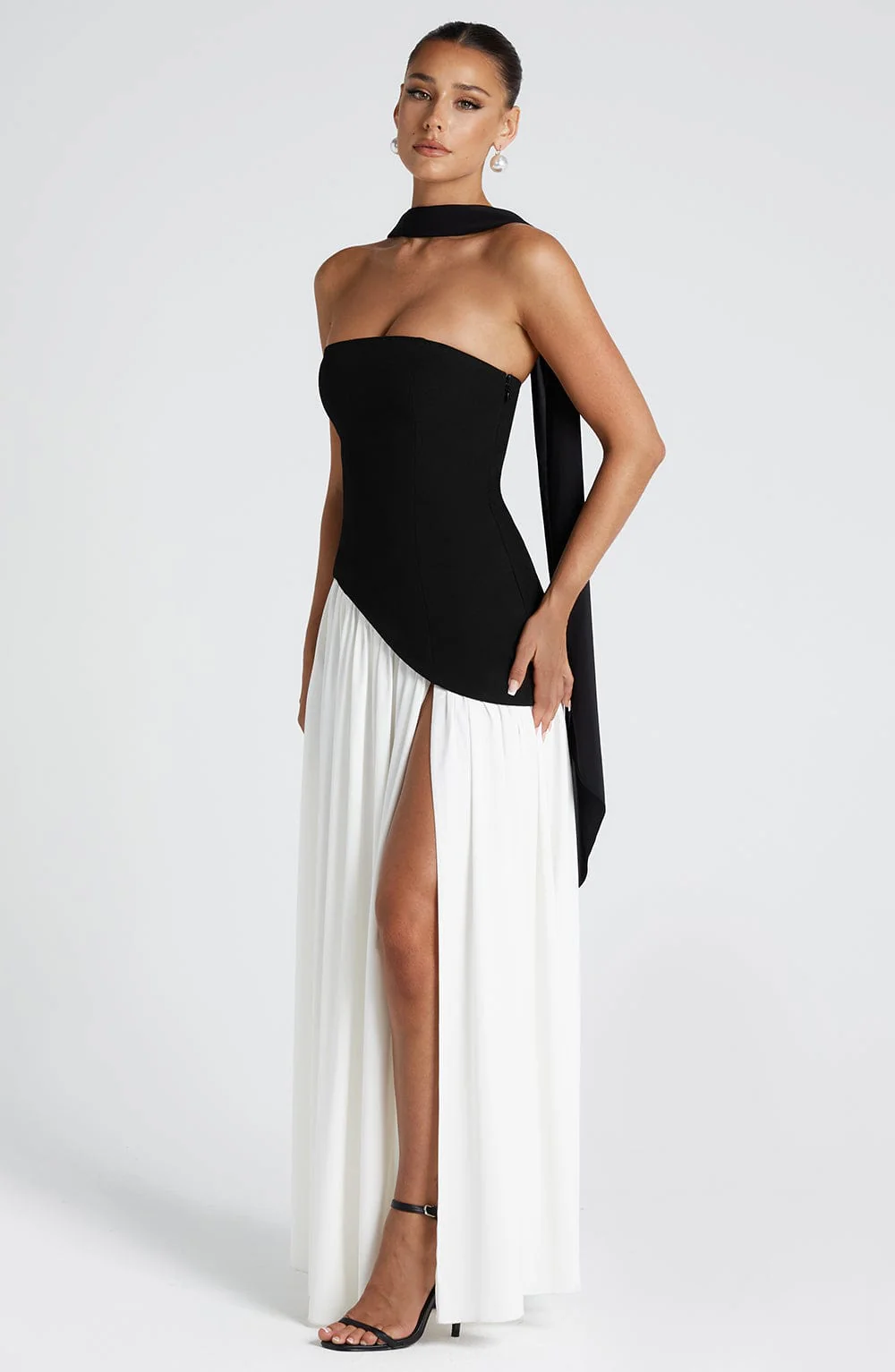 Woman wearing strapless split evening maxi dress