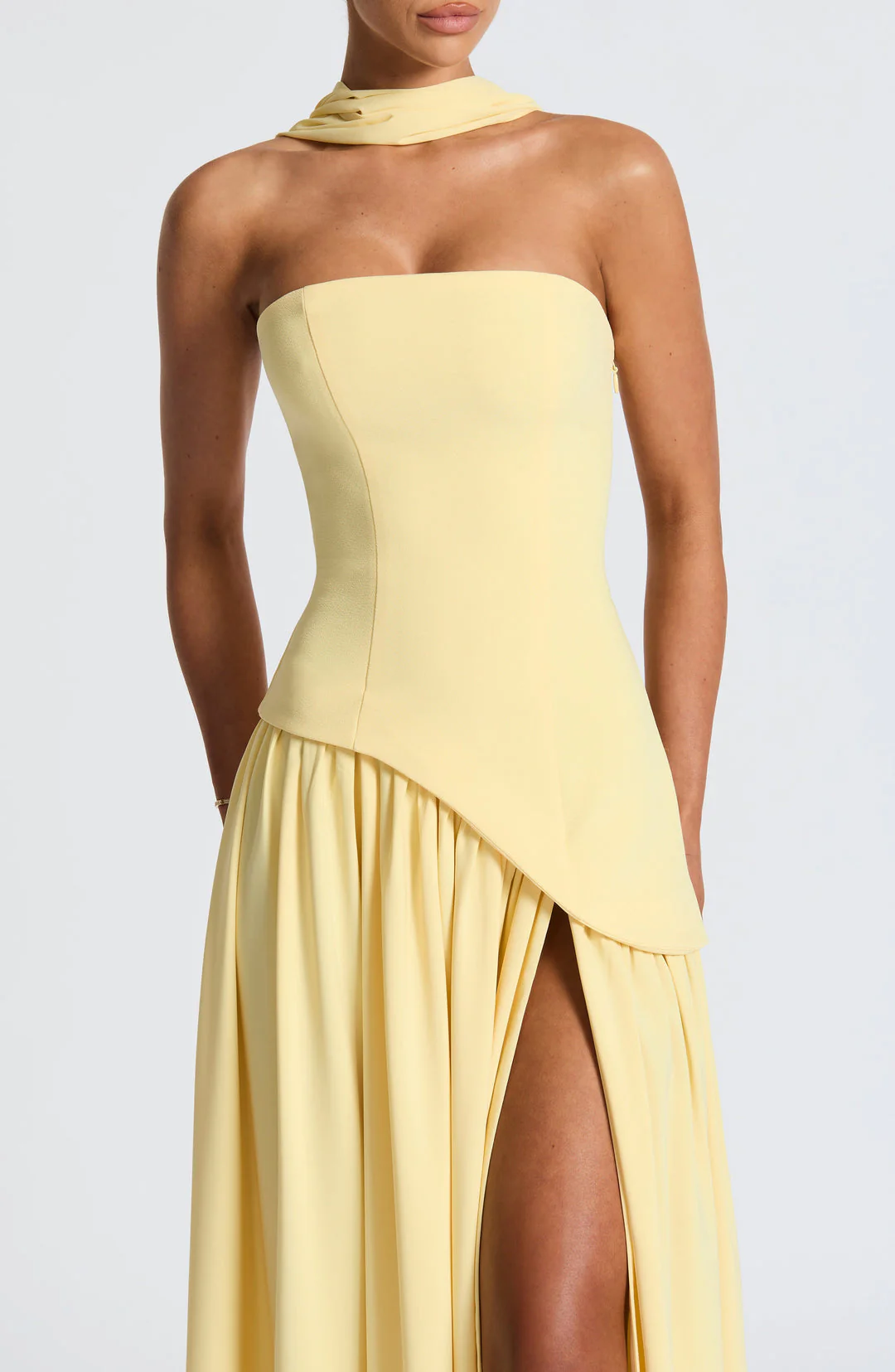 Woman wearing strapless split evening maxi dress