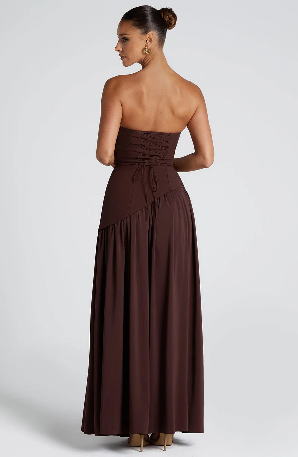 Woman wearing strapless split evening maxi dress