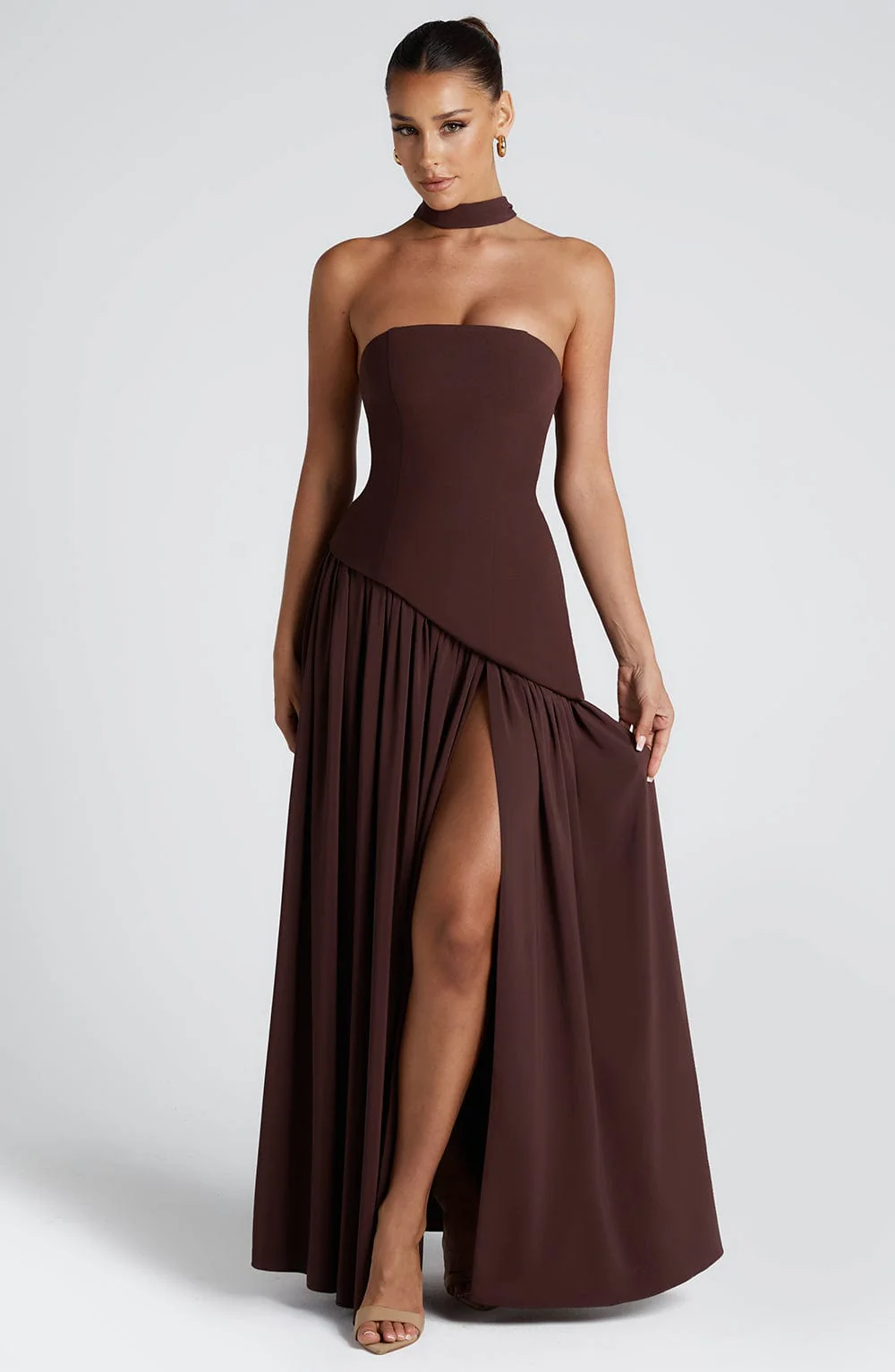 Woman wearing strapless split evening maxi dress