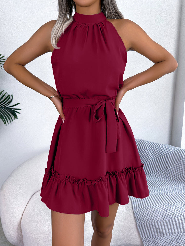 Woman wearing halter neck ruffle mini dress