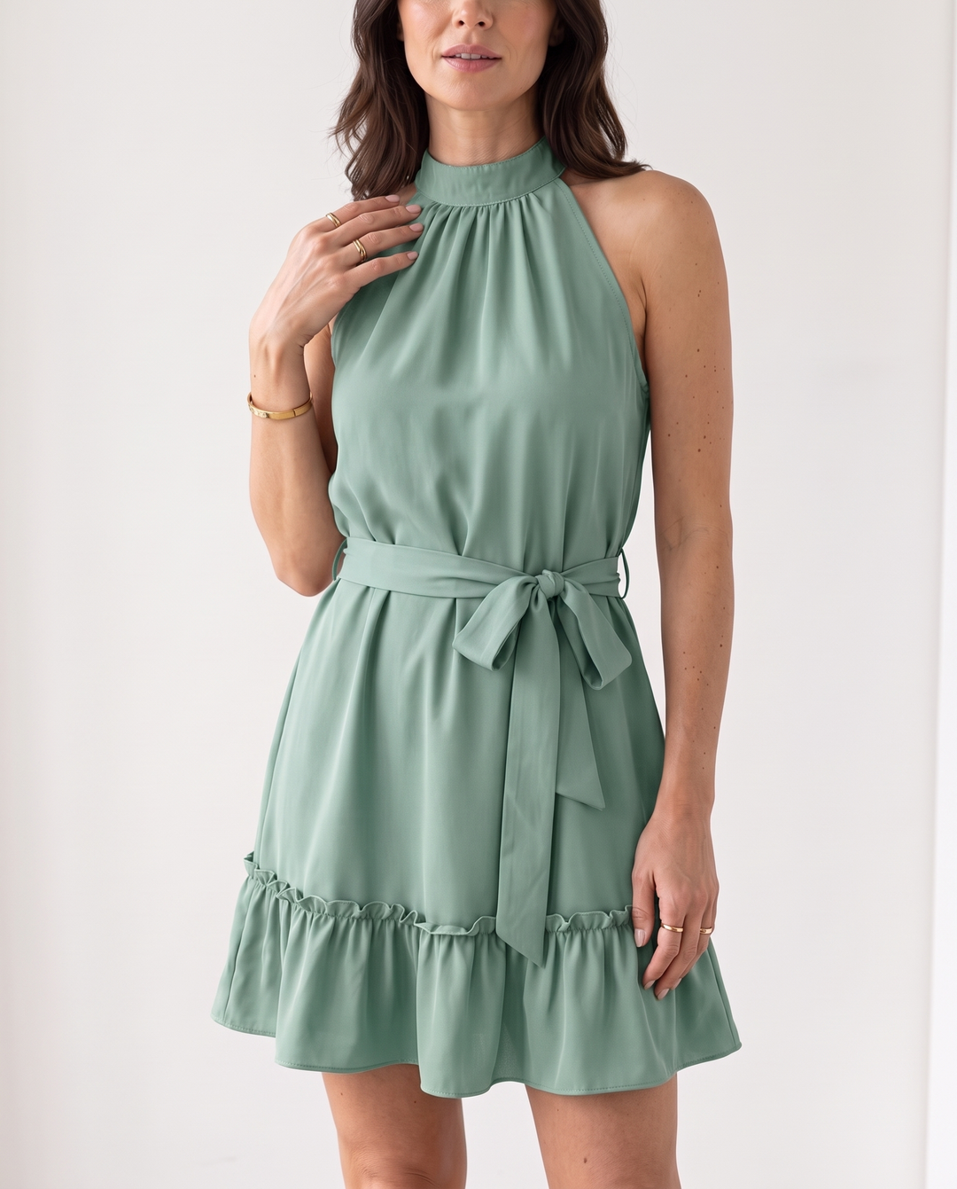 Woman wearing halter neck ruffle mini dress