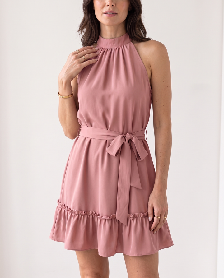 Woman wearing halter neck ruffle mini dress