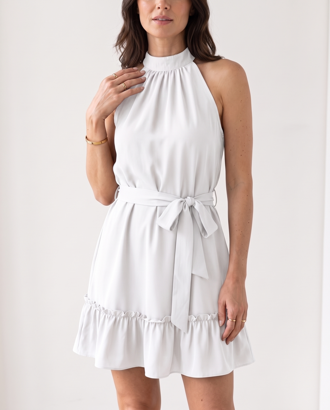 Woman wearing halter neck ruffle mini dress