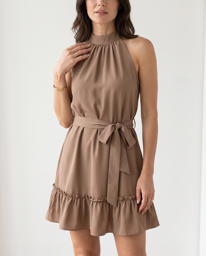 Woman wearing halter neck ruffle mini dress