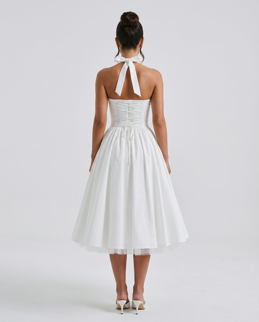 Woman wearing elegant white midi dress