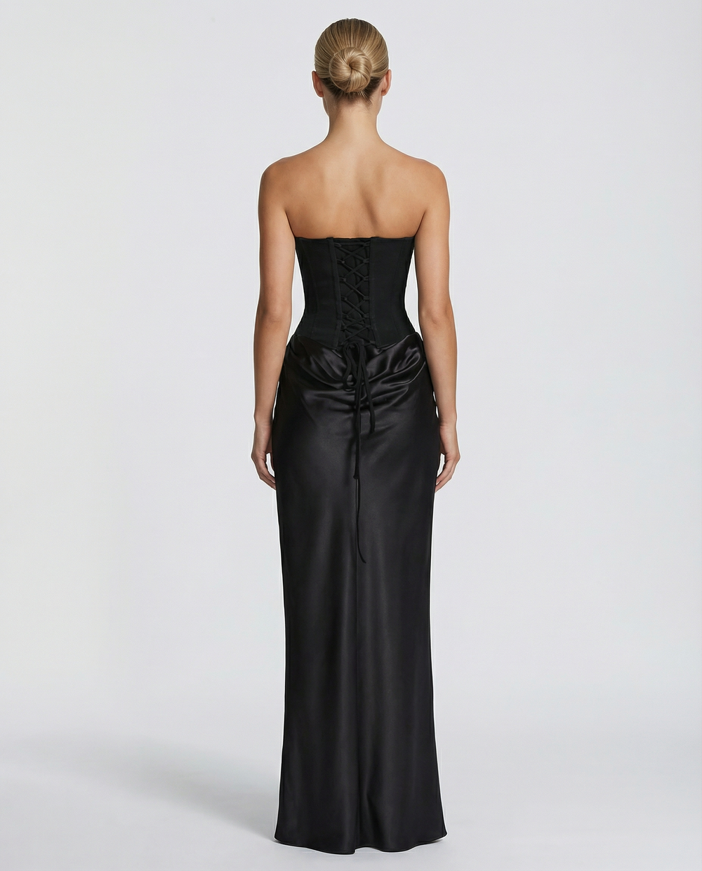 Woman wearing black satin corset maxi dress