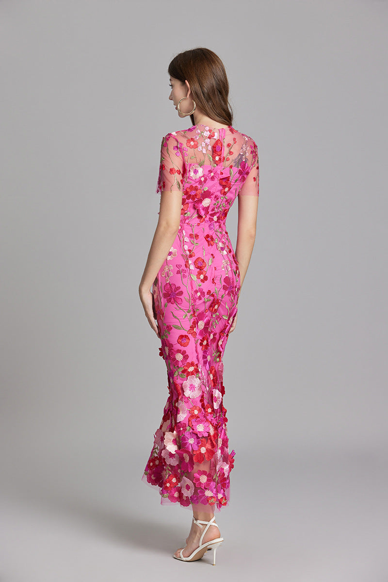 Woman wearing floral embroidered midi dress