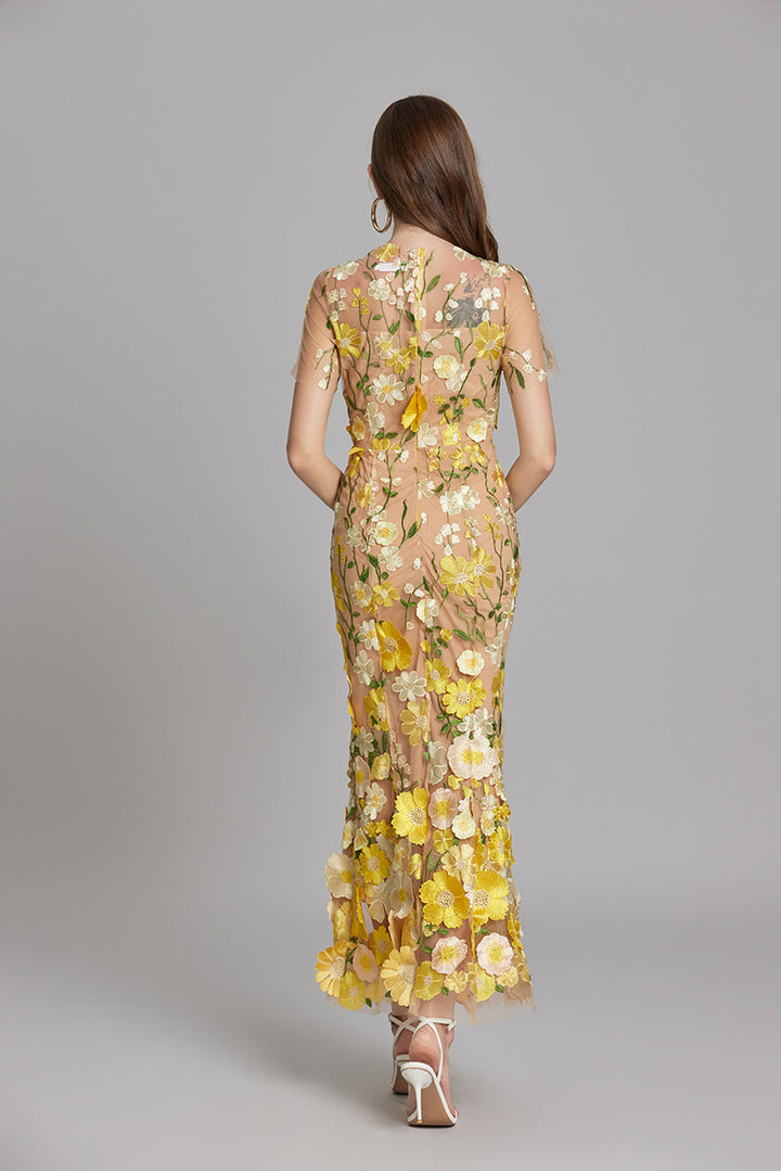 Woman wearing floral embroidered midi dress