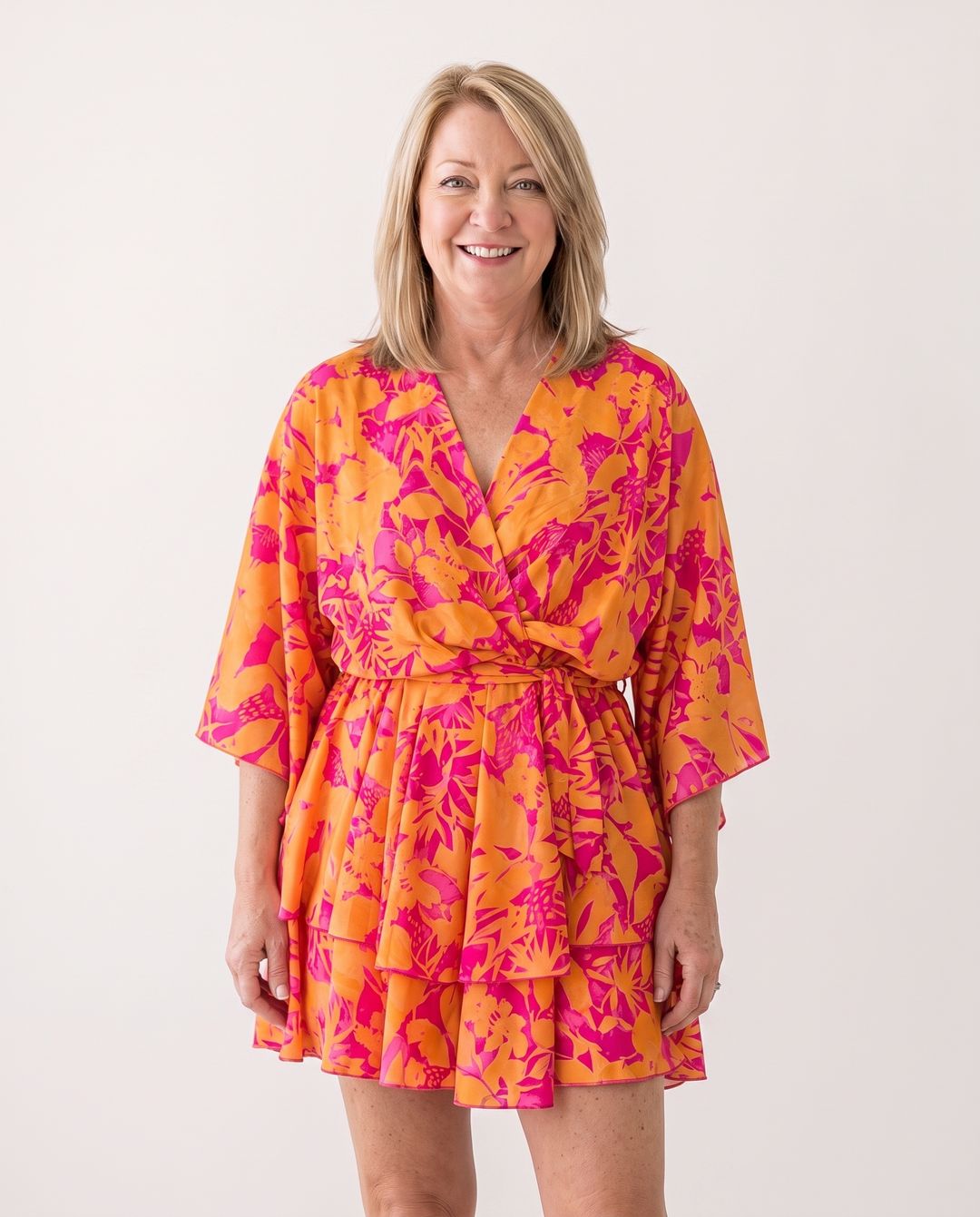 Woman wearing twist-front floral mini dress with layered ruffles