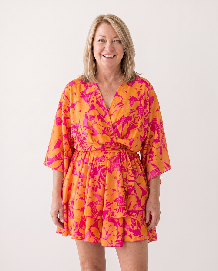 Woman wearing twist-front floral mini dress with layered ruffles