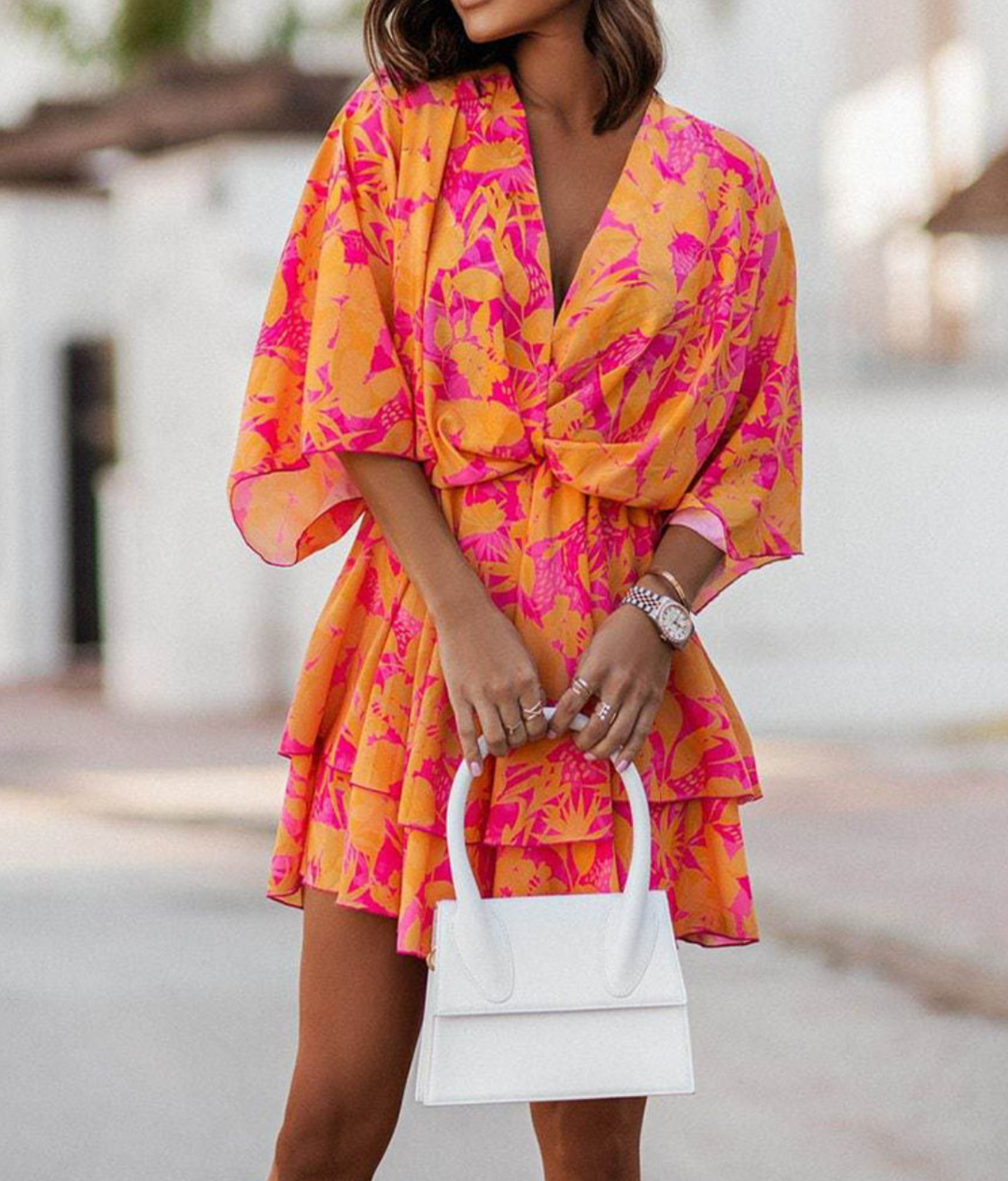 Woman wearing twist-front floral mini dress with layered ruffles