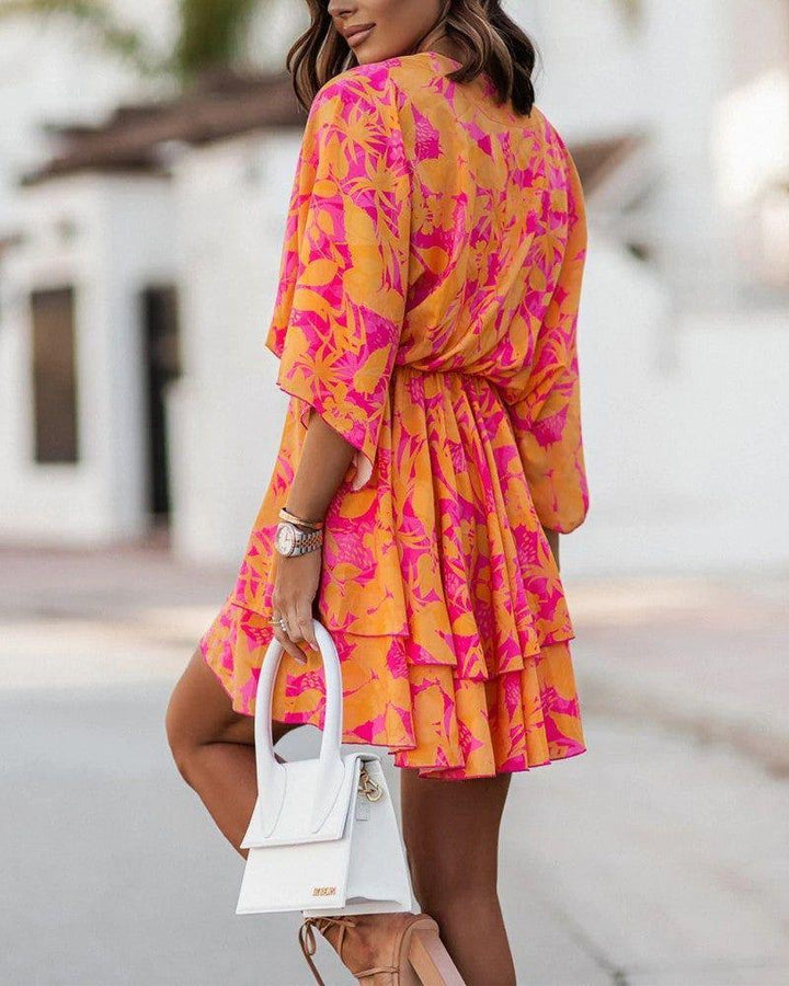 Woman wearing twist-front floral mini dress with layered ruffles