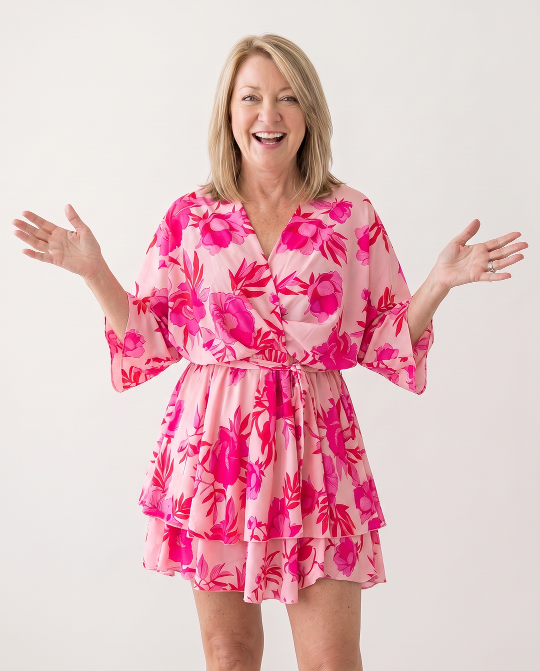 Woman wearing twist-front floral mini dress with layered ruffles