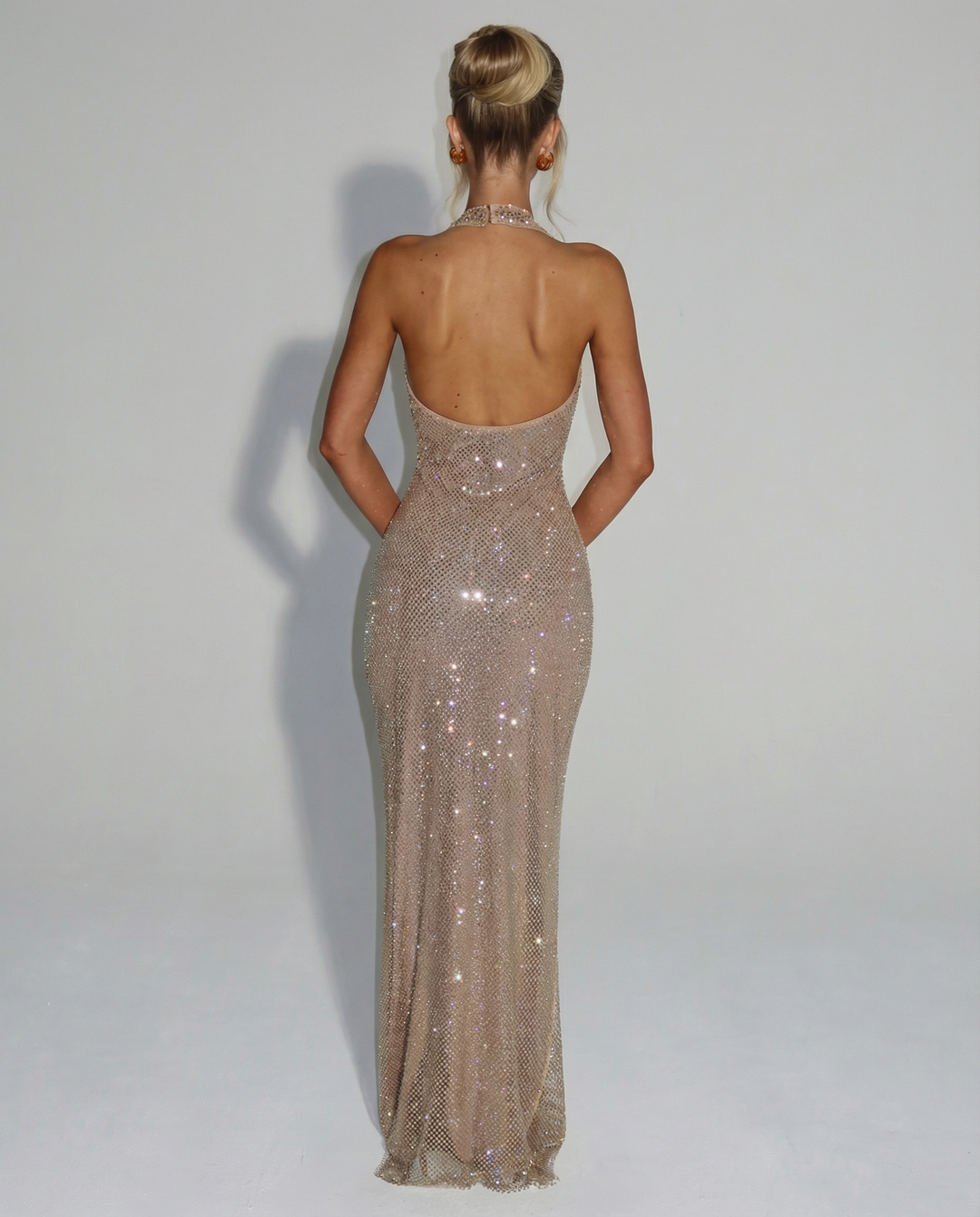Woman wearing sequin halter maxi dress