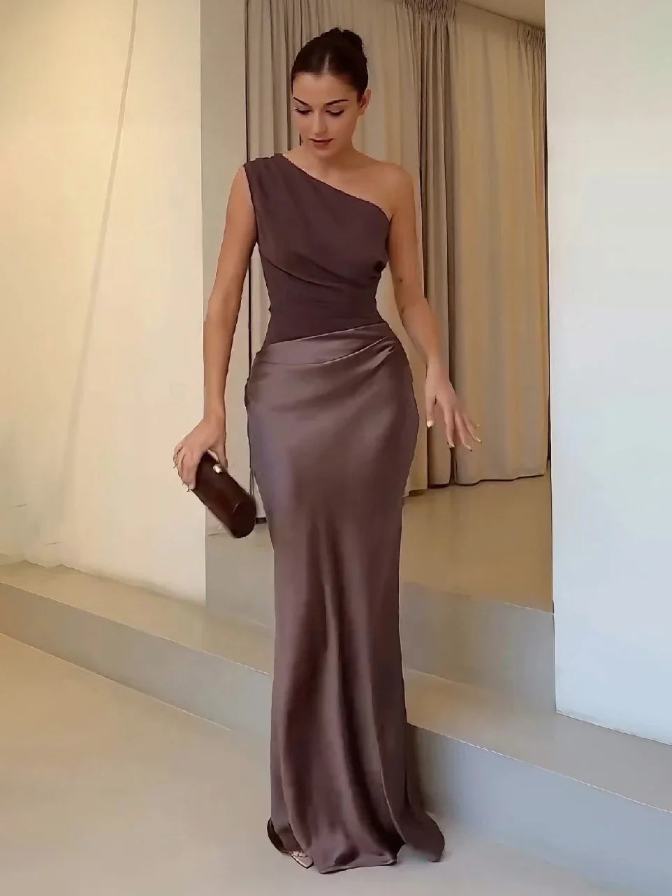 Woman wearing one-shoulder satin evening dress